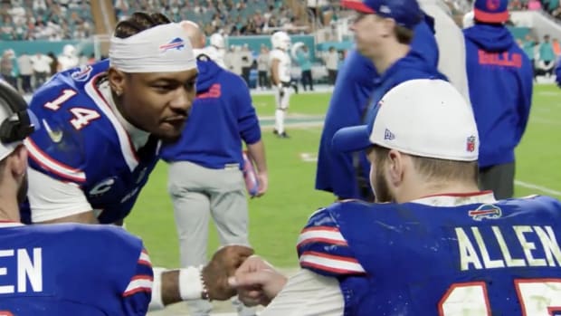 Bills receiver Stefon Diggs fist pumps quarterback Josh Allen on the sideline.